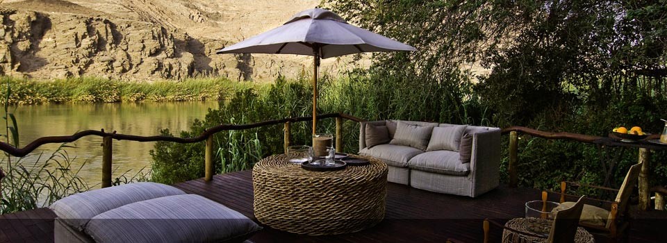 Relax and take in the view from the deck at Serra Cafema Camp 