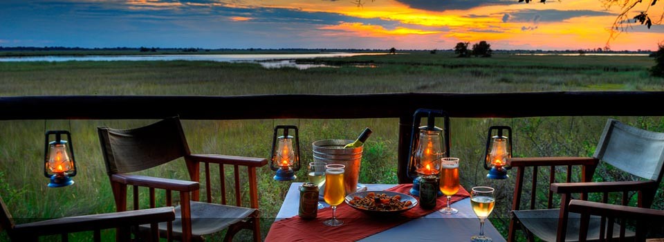 Enjoy a sunset drink over looking the Okavango Delta at Camp Moremi