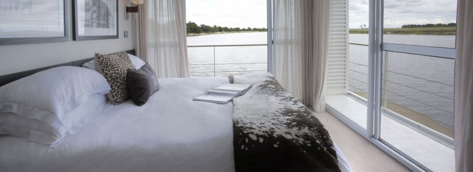 Relax in the luxury suites of the Zambezi Queen on Botswana's Chobe River.