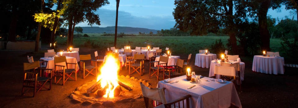 Dining around the camp fire at Little Governors' Camp in the Masai Mara