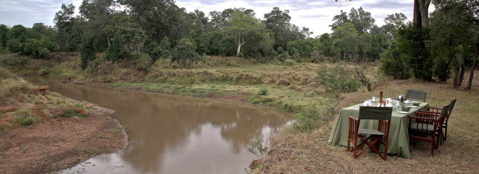 Dining with river views at Governors' Private Camp in the Masai Mara